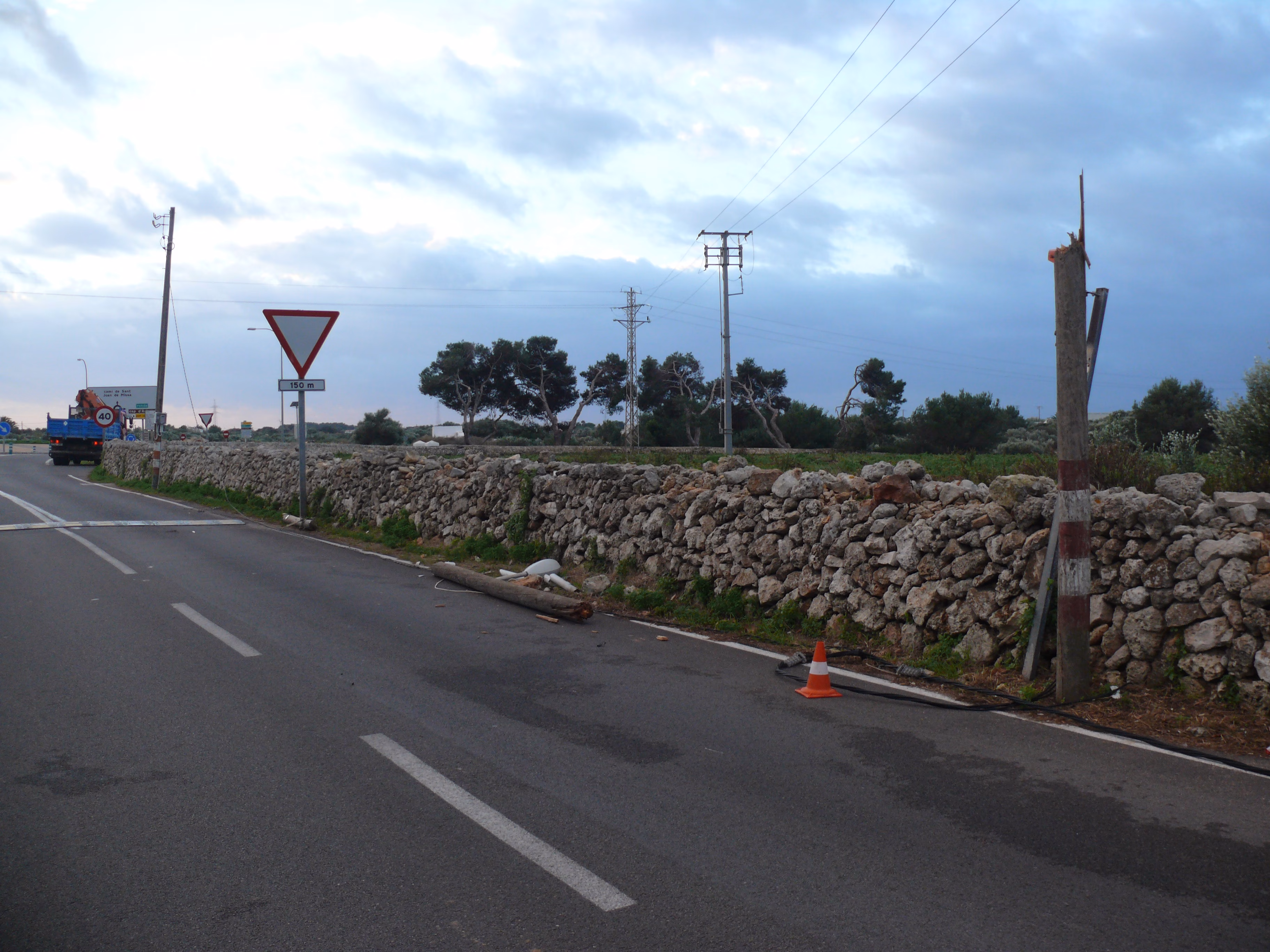 Un camión-grúa tumba dos postes y farolas en el camino de Sant Joan de Missa