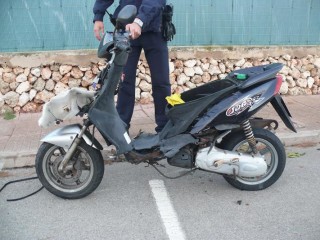 Un agente inspecciona la moto tras el accidente (Foto: Policía Local de Ciutadella)