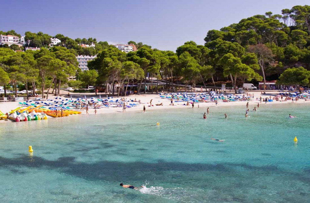 Cala Galdana con arena y turistas