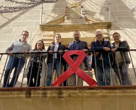 Miembros del equipo de gobierno, junto al lazo rojo (Foto: Ajuntament d'Alaior)