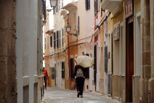 Una persona con paraguas en el centro de Ciutadella (Foto: Cris Ruiz)