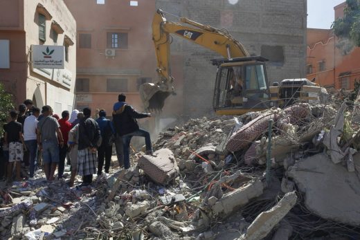 Una excavadora entre ruinas tras el terremoto.